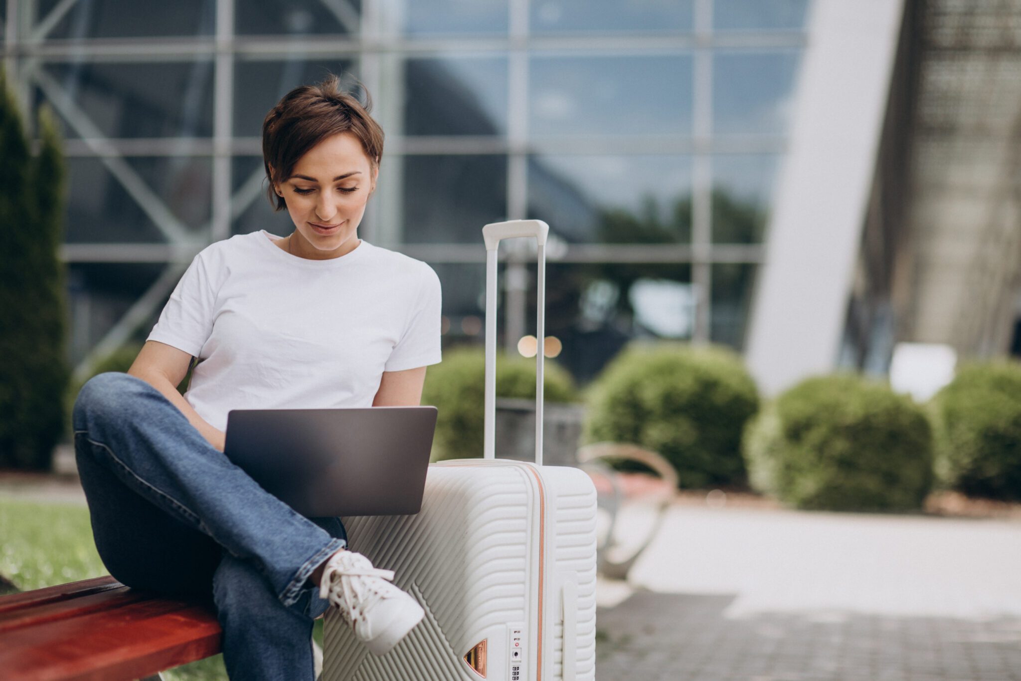woman travelling working computer airport scaled
